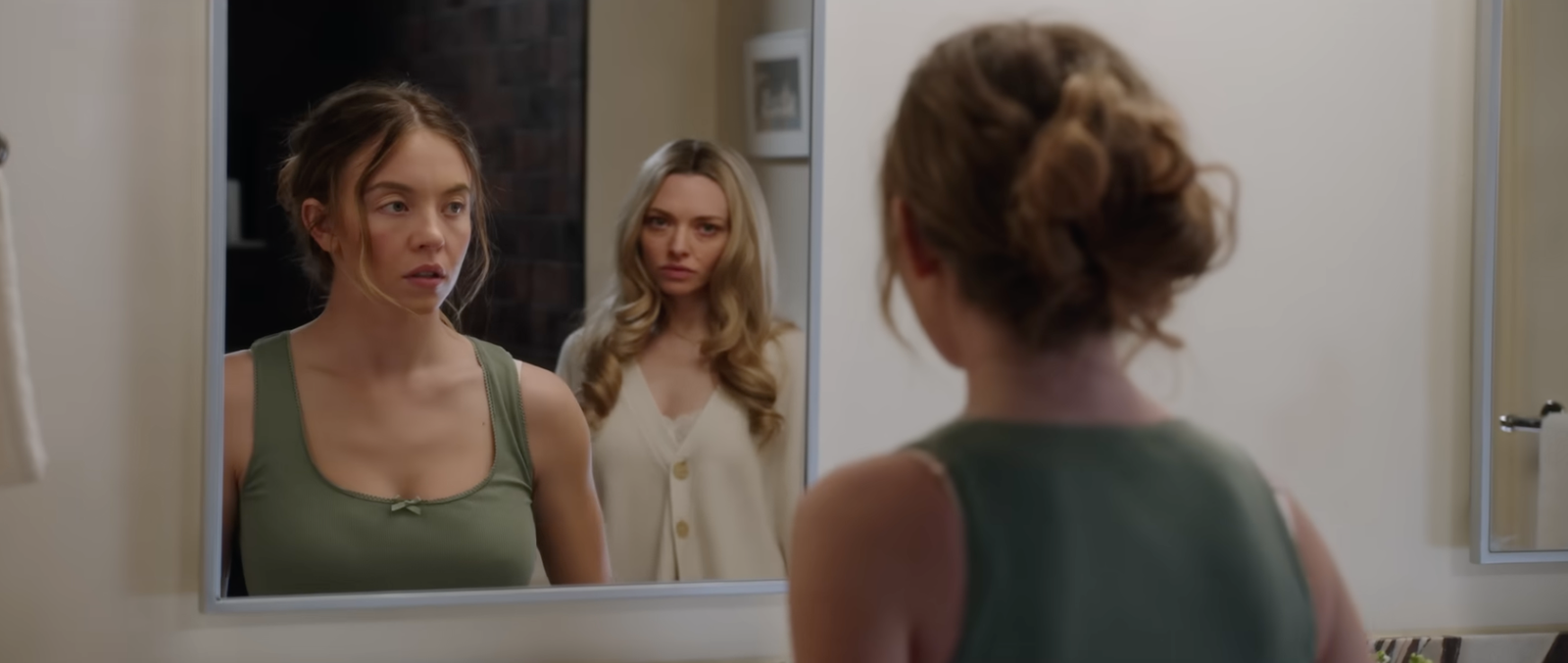 amanda seyfried and sydney sweeney reflection in a mirror in the housemaid movie