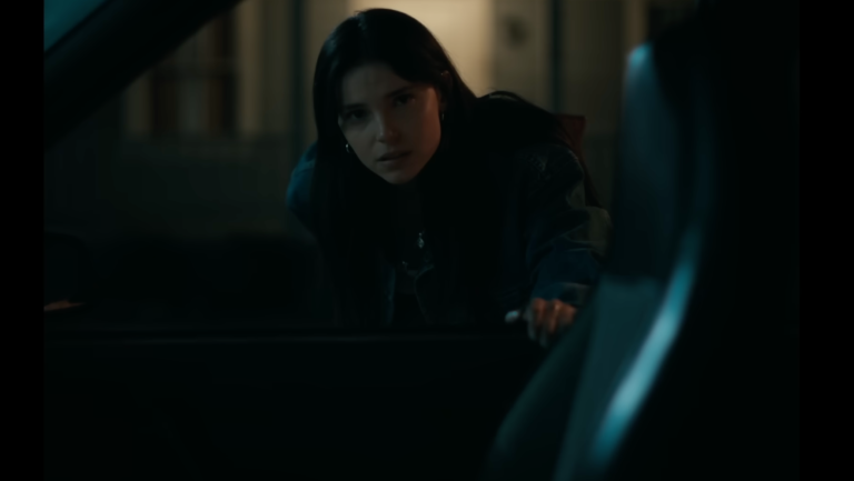 Nikki looking in the car in Obsession